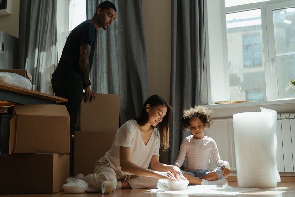 A family enjoying moving day, unpacking and organizing belongings in their new apartment.