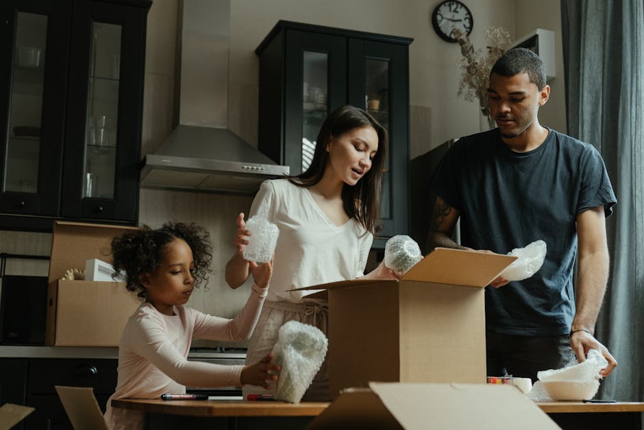 A family unpacks boxes in their new home kitchen, symbolizing a fresh start.